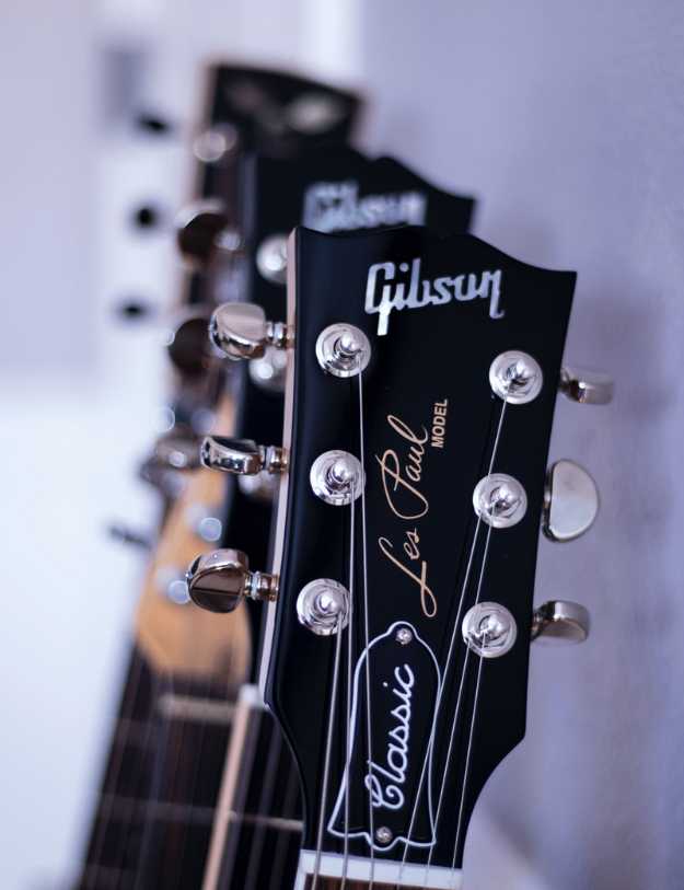Close up of four guitars leaning on their sides